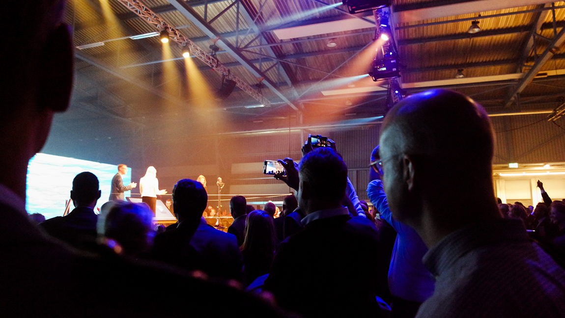 People filming at event
